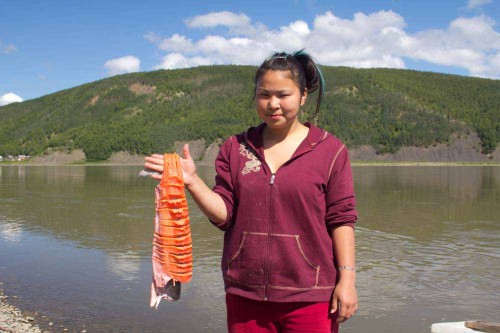 Young Native Yupic With Salmon